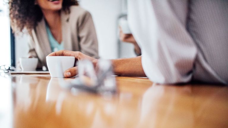 Two people sitting together having coffee