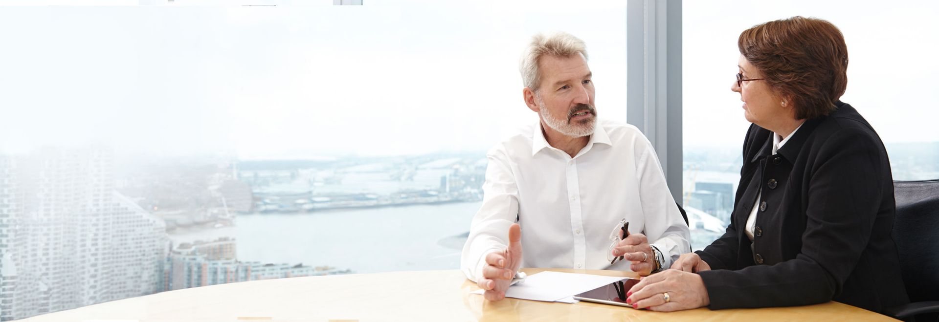 A man and woman have a business meeting in a city office