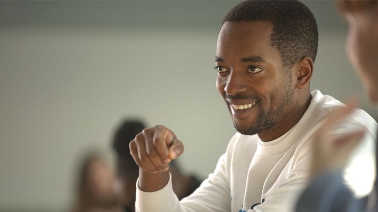  A man smiling at the person opposite him