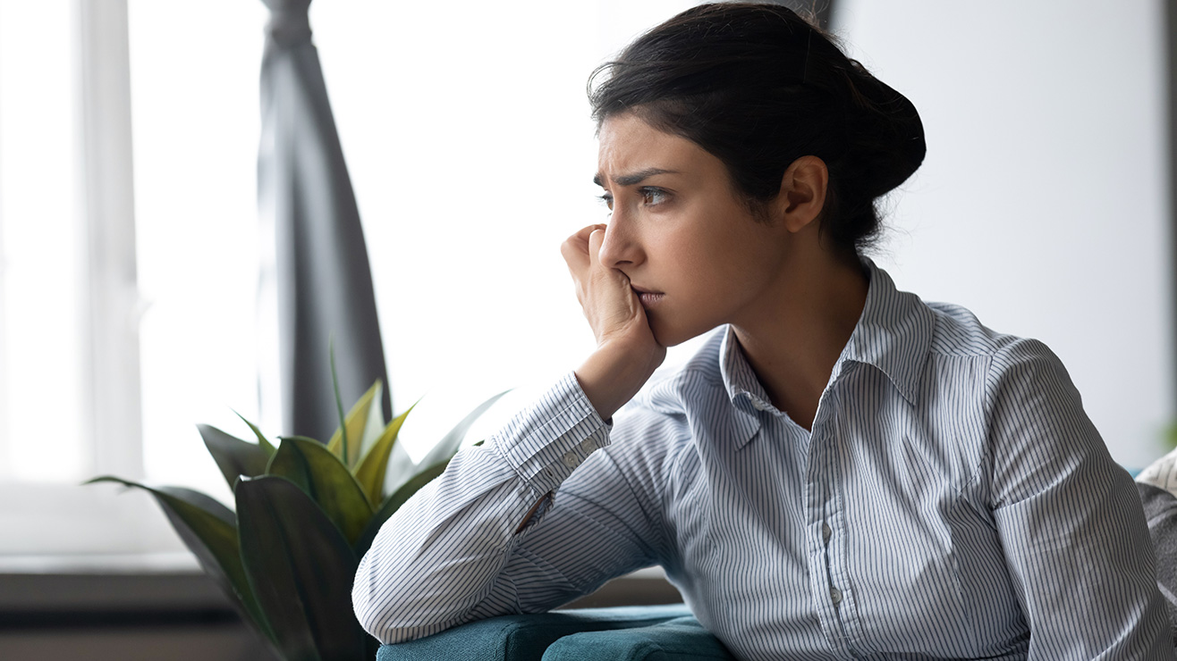 Person sitting on sofa looking worried