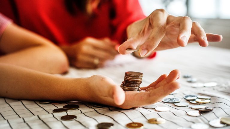  A woman and a child stack up coins on a table